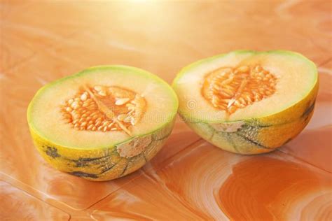 Orange Cut Melon With Seeds Inside Two Halves Of A Beautiful Me Stock