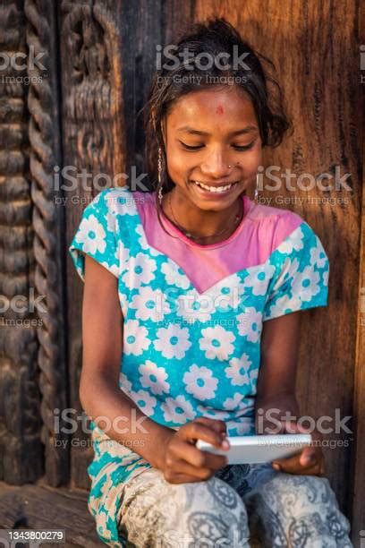 Portrait Of Happy Young Nepali Girl Using A Mobile Phone In Bhaktapur