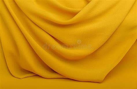 Background Texture Pattern Wavy Yellow Silk Fabric Stock Photo
