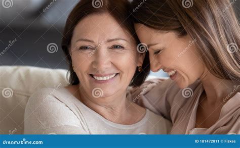 Close Up Smiling Mature Mother And Daughter Hugging Touching Heads