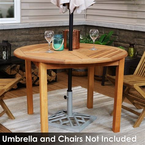 An Umbrella And Chairs Are Set Up On The Patio For Drinks To Be Enjoyed In