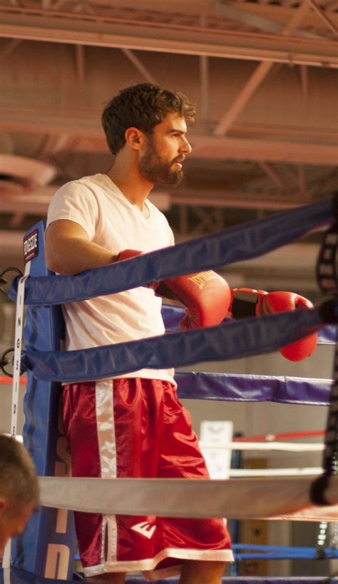 a man standing next to a boxing ring