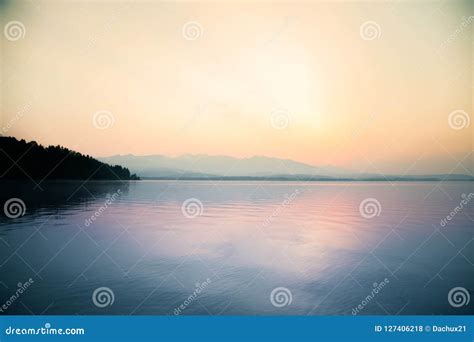 A Beautiful Calm Morning Landscape Of Lake And Mountains In The