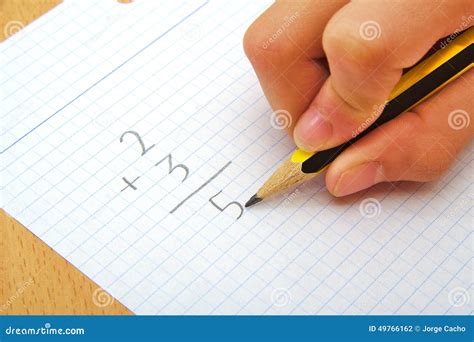 Hand Of A Child Making A Sum Math School Concept Stock Photo Image