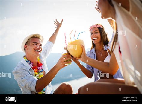 Group Of Friends At Beach Drinking And Having Fun Summer Party Stock