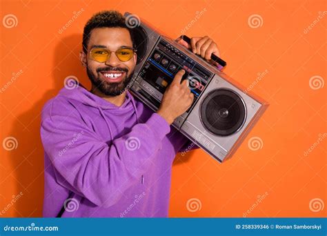 Portrait Of Cheerful Excited Guy Carry Boombox Turn On Song Have Good