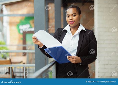 african american businesswoman in office attire smiling looks confident and happy successful