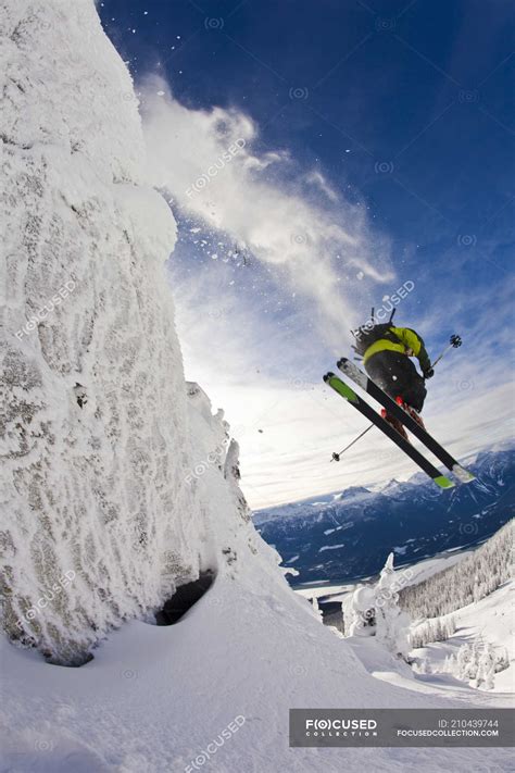 Male Skier Jumping From Cliff In Revelstoke Mountain Resort Revelstoke Backcountry Canada