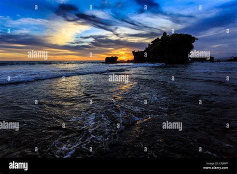 Tahah Lot Temple And Ocean Waves At Sunset Bali Indonesia Stock Photo