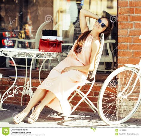 Young Pretty Brunette Woman After Shopping Sitting At Cafe Outside On