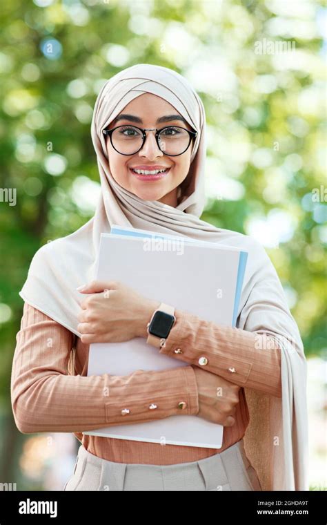 Cheerful Glad Cute Young Arab Muslim Female Student In Hijab And