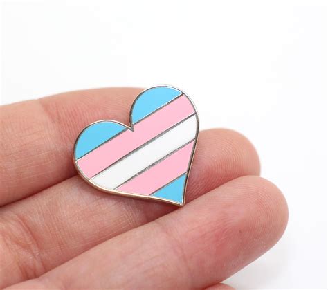 People who do not identify with the gender they were assigned to when they were born. Transgender Flag Heart Pin | Compoco Pop
