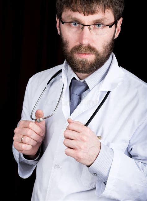 Doctor In A White Medical Robe Standing And Holding A Stethoscope