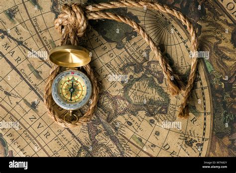 Old Compass On Vintage Map With Rope Closeup Retro Stale Stock Photo