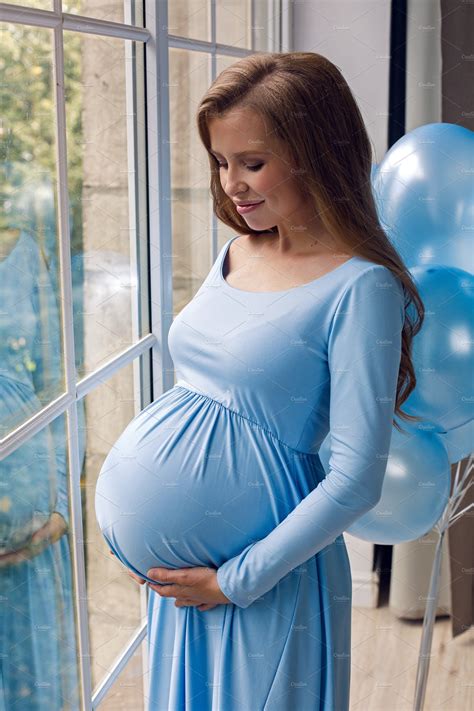 Beautiful Young Pregnant Girl In Blu Containing Pregnant Belly And