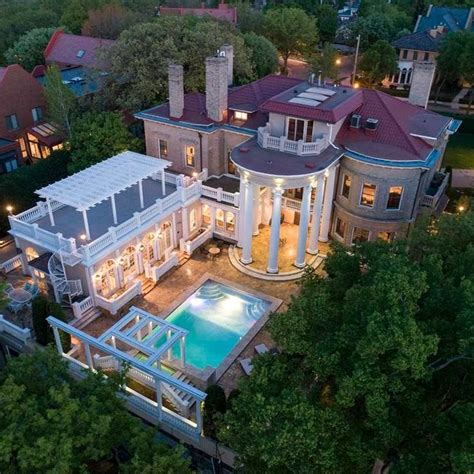 An Aerial View Of A Large Mansion With A Swimming Pool In The