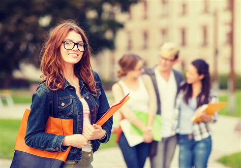 female student in eyglasses with folders Образование и транспортно