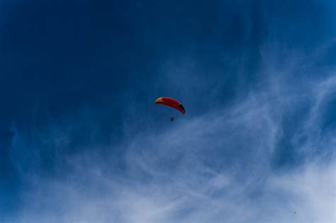 Person On Parachute Flying In The Sky · Free Stock Photo