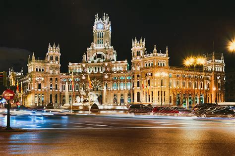 6.5 million people live in the autonomous community of the same name. lights asphalt night madrid town building road spain architecture machinery HD wallpaper