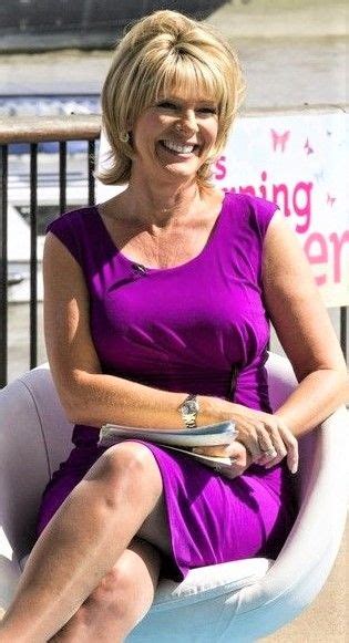 A Woman In A Purple Dress Is Sitting On A White Chair And Smiling At