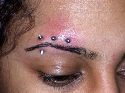 Heritage Tattoo Eyebrow Piercing