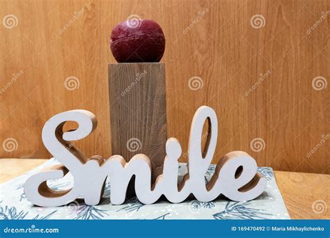 Word Smile From Wooden Letters On Table In Interior Stock Photo