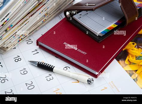 Business Diary With Pen Calendar Sketchpad Stack Of Newspapers Stock