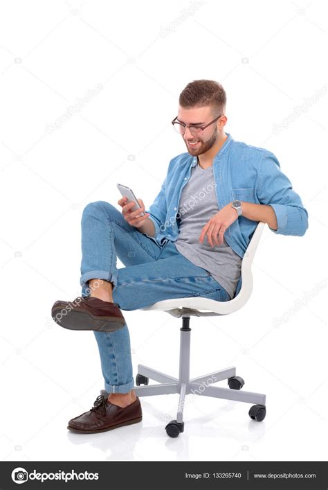 Young Man Sitting On Chair And Using Mobile Phone — Stock