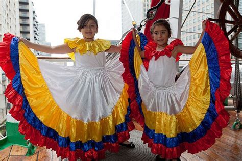Two Young Girl Dancers Display Their Traditional Colombian Dresses In