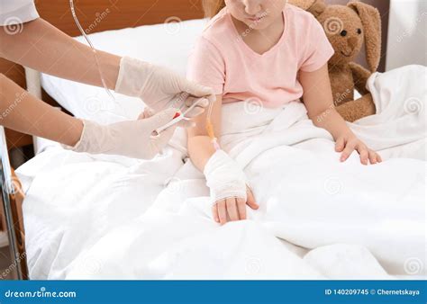Doctor Adjusting Intravenous Drip For Little Child Stock Image Image