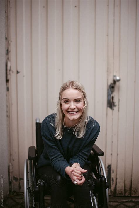 overjoyed woman on wheelchair at city street by stocksy contributor chris zielecki stocksy