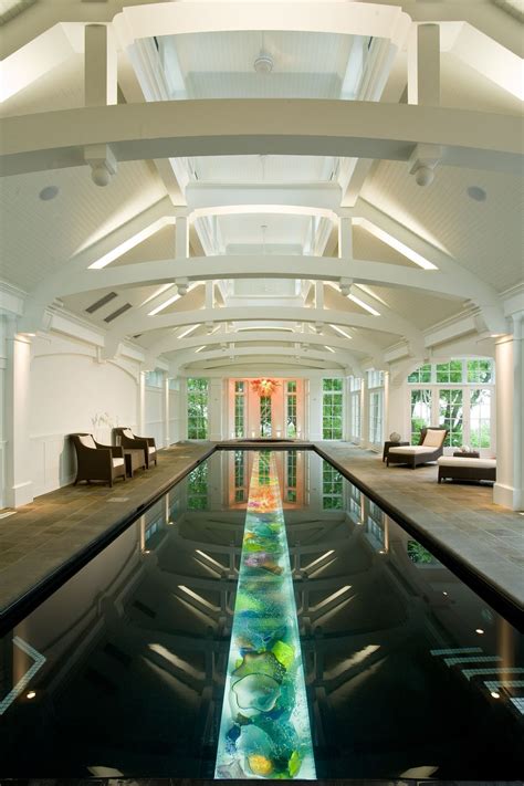 Indoor Pool Room Features A Vaulted Ceiling And A Lap Pool With Art