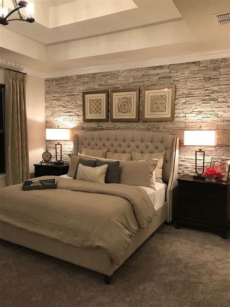 Master Bedroom With Stacked Stone Accent Wall And Upholstered Bed