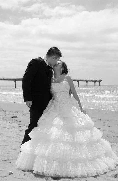 Attractive newly married couple taking time to themselves walking along a beautiful sandy beach. Destination Beach Wedding Venues in New Zealand | New ...