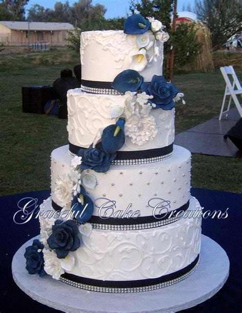 Elegant White Butter Cream Wedding Cake With Navy Blue Ribbon And Bling