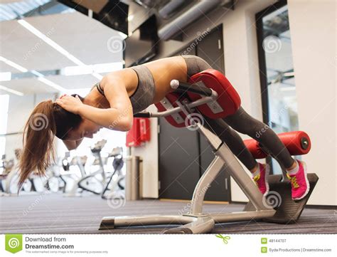 Shot of a woman's back muscles while lifting weights. Young Woman Flexing Back Muscles On Bench In Gym Stock Image - Image of exercise, bench: 48144707