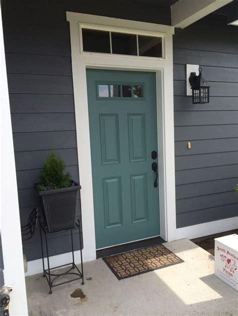 Chic cottage home features taupe siding framing a turquoise front door flanked by sidelights. Image result for grey house teal front door and navy shutters | Home Exterior | Pinterest | Navy ...