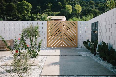 Pagar kayu dengan pintu gerbang unik. 7 Contoh Rumah Minimalis yang Mudah Anda Tiru