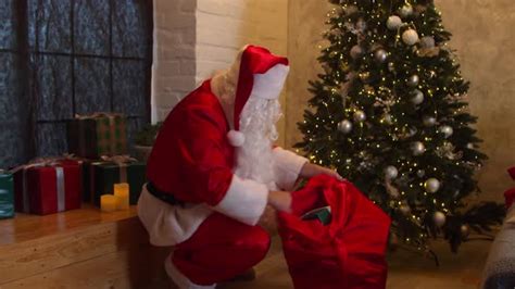 Santa Claus Putting T Boxes Under Christmas Tree Stock Footage
