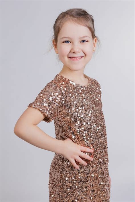Smiling Little Girl In Golden Dress In Studio Stock Image Image Of