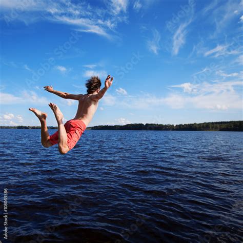 Young Man Jumping Into Water Stock Photo Adobe Stock