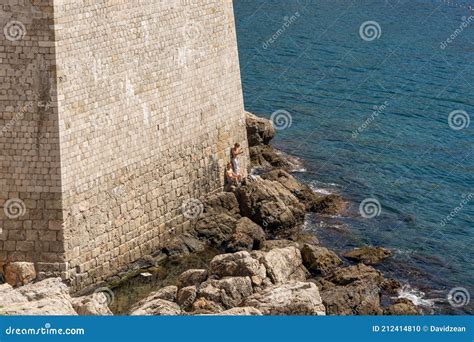 dubrovnik croatia aug 22 2020 two half naked man below fort st margaret of city wall in