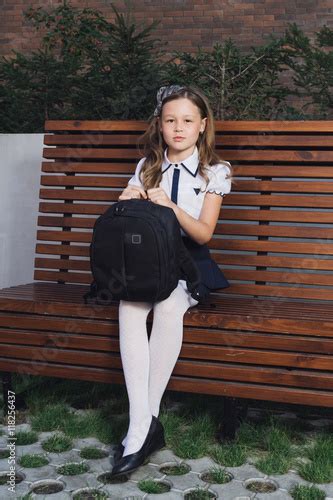 Schoolgirl In Uniform Waiting For The Bus To School Schoolgirl In A