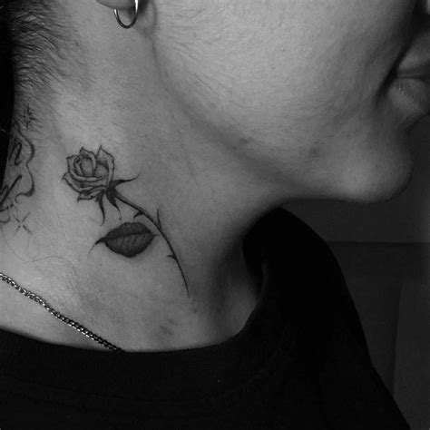 Rose Tattoo On The Right Side Of The Neck