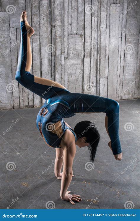 circus gymnast woman flexible body standing on arms upside down balancing balls on feet