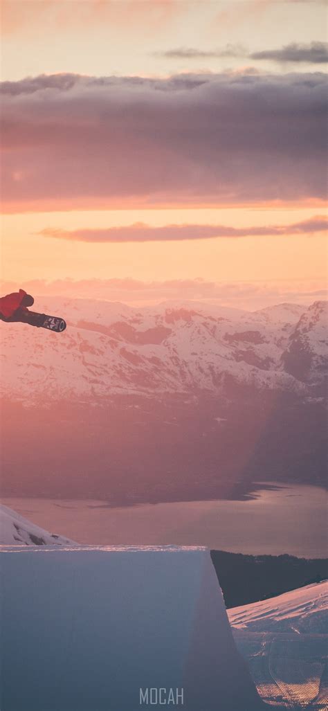 271642 A Snowboarder Is Airborne Surrounded By Golden Skies And Snowy