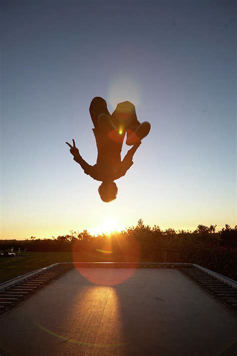 Man Doing Backflip On Trampoline Photograph By Ubald Rutar