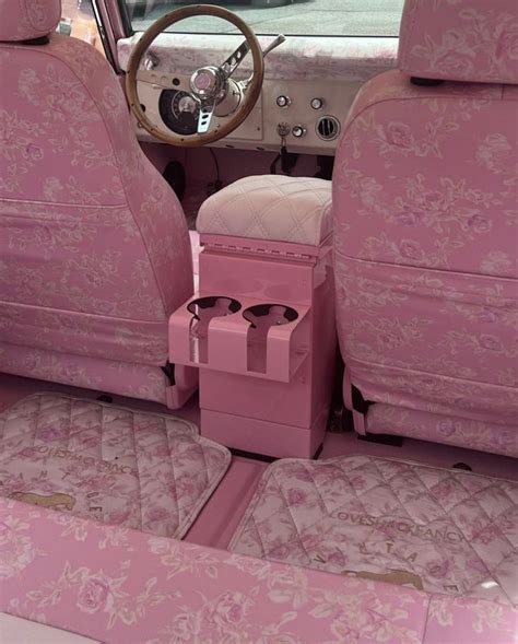 The Interior Of A Pink Car With Floral Print Upholstered Seats And