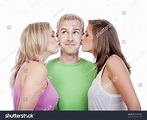 Two Young Women Kissing Handsome Man Standing Between Them - Isolated ...