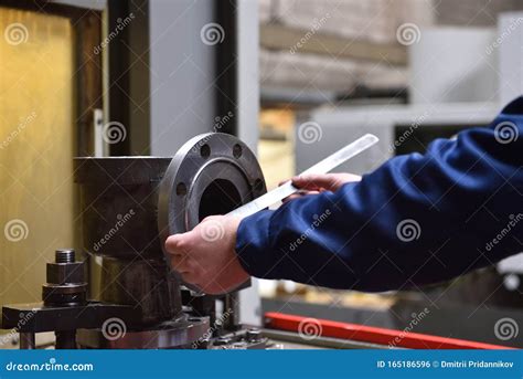 A Factory Worker Measures With A Ruler The Diameter Of The Valve`s